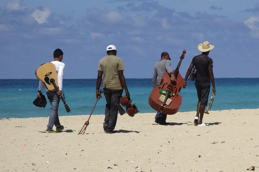 A group of friends who are musicians walking alongside the beach for Hidden Beach Day blog post image for Hidden Beach Recordings